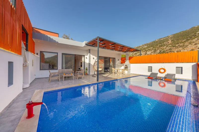 Backyard swimming pool with a deck and patio furniture
